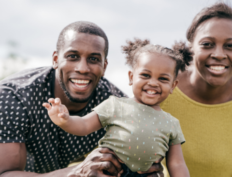 Happy family of color smiles and celebrates together